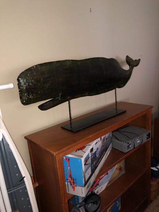 Wooden bookcase and whale mantle decoration