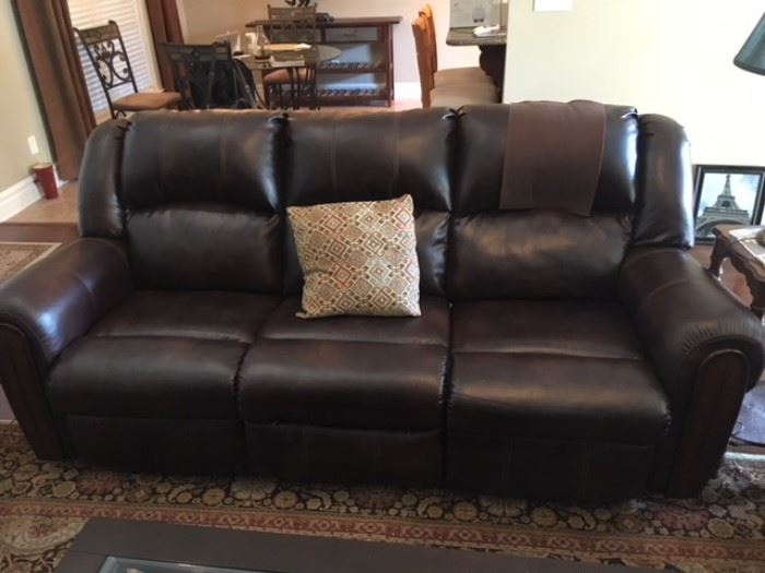Leather Reclining sofa ( some damage to the head of left side ) 
