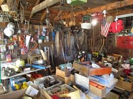 This garage will amaze- especially if you like fiddlin' around- all kinds of tools, nuts, bolts, screws, nails, by the pound- peg board loaded with more tools- plus a nice selection of garden tools, shovels, rakes, its STUFFED in the garage-