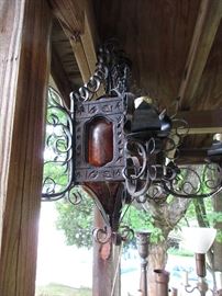 This light you have to see to appreciate- a carved wood body frames amber crackled blown glass panels- the arms support an additional single light per arm- I suspect Mexican from the early 60's- beefy and stout- way cool lit.