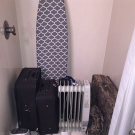 suitcases, heater, and brand new ironing board