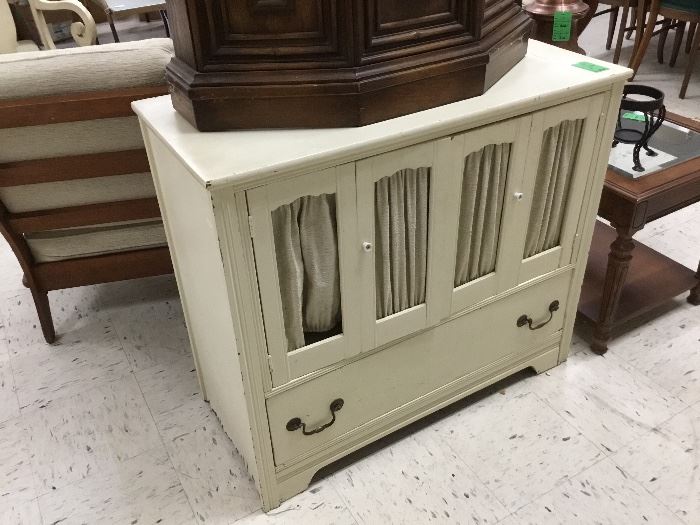 Table with bottom drawer - would be great to repurpose this with some wire or tin where fabric is on doors and paint it!