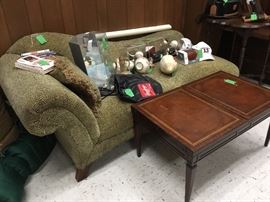 Green chaise lounge with football and baseball memorabilia 