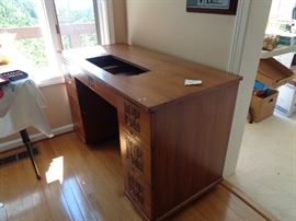 teak, think it is handmade sewing cabinet, have machine, back folds out for fabic handling