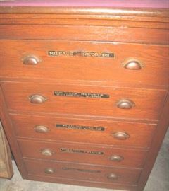 Five drawer oak chest with drawers marked records and reports.