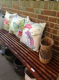Decorative pillows; redwood bench; planters