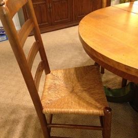 One of several ladder back chairs with rush seats