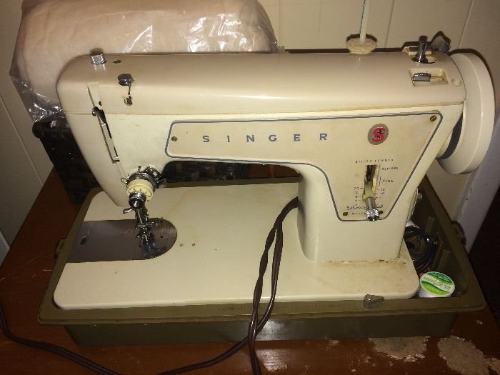 Singer vintage sewing machine with case and attachments