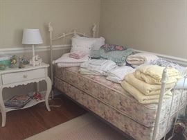 Twin Iron bed with mattress set, twin sheet sets, duvet, pillow shams and coverlets, and an electric blanket also
