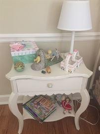 Nightstand with Winnie-the-Pooh book ends, children's books, and vintage dolls - American Girl Dolls with accessories also available