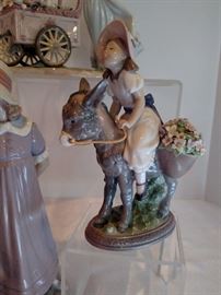 Lladro on donkey with bouquet in basket 