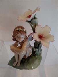 Lladro girl sitting with porcelain flowers