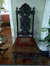 Antique black walnut ornately carved chair
