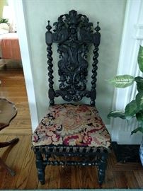 Antique black walnut ornately carved chair
