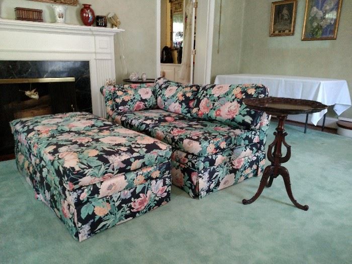 Floral print settee with two ottomans and a mahogany tea table