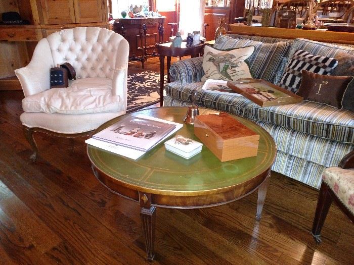 Leather top round coffee table and velvet upholstered settee