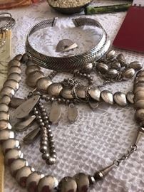 A collection of silver  Jewelry .the  silver  hand  woven  necklace is   from  a  famed  gallery 