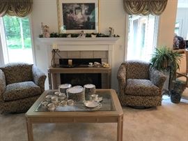 Living Room grouping of chairs, coffee table, sofa table (in front of fireplace), etc.  Set of dishes is by Gibson