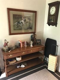 Sofa table, misc decorative items.  On wall: 