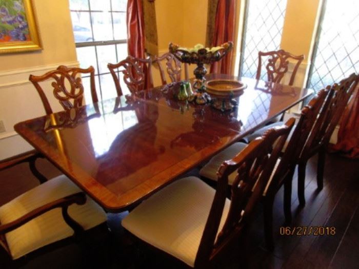 Beautiful dining table with 8 chairs.  High sheen on table.  Has custom table pads.  