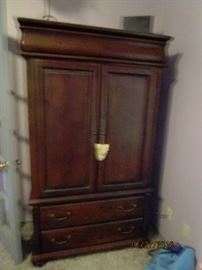 6' Armoire.  Has 2 bottom drawers, 2 shelves inside and a hidden side  drawer