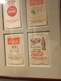Framed vintage Coke memorabilia.