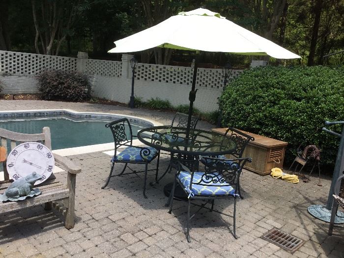 Wrought iron table, chairs and umbrella. No, the pool isn’t formsale😩