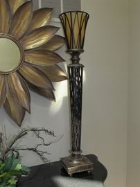 BEAUTIFUL DECOR - LARGE LOVELY CONVEX MIRROR SURROUNDED BY TEXTURED GOLDEN METAL PETALS AND A TALL AMBER AND BRONZE LAMP