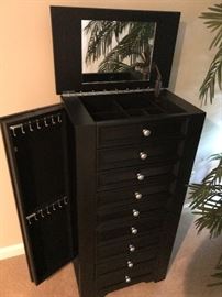 BLACK OXFORD JEWELRY ARMOIRE WITH SIDE DOORS AND FLIP-TOP STORAGE WITH MIRROR.
