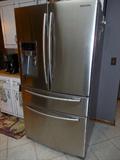 LARGE STAINLESS STEEL SAMSUNG REFRIGERATOR WITH ALL THE GADGETS. LESS THAN 2 YEARS OLD