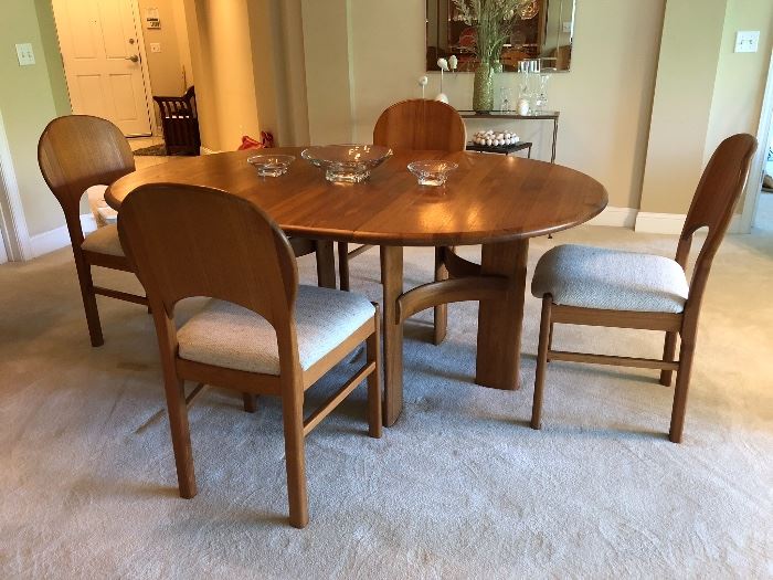Ansager Mobler solid teak dining set.  Comes with 6 dining chairs & two leaves.  Extends from a 47” circle(not photographed) to 87” long