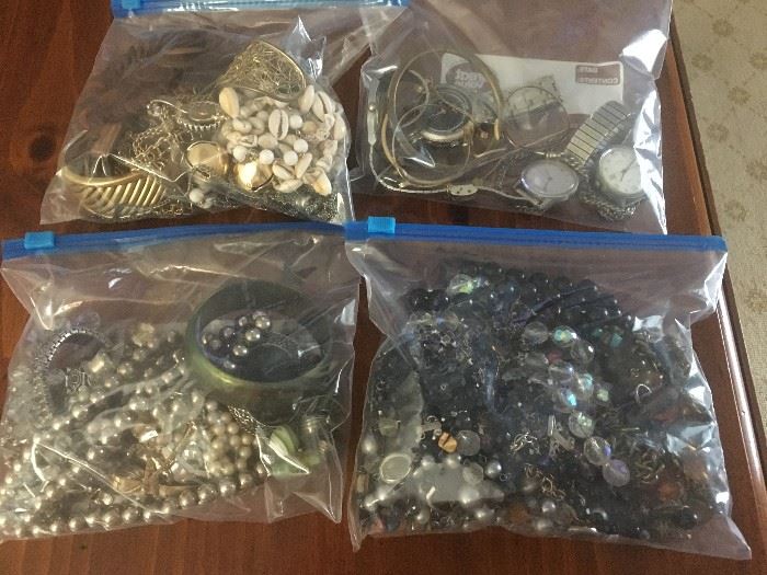 FOUR LARGE BAGS OF COSTUME JEWELRY AND WATCHES