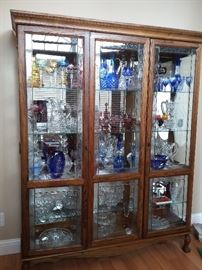 Lighted Curio Cabinet packed with brilliant cut and cut to clear Glassware