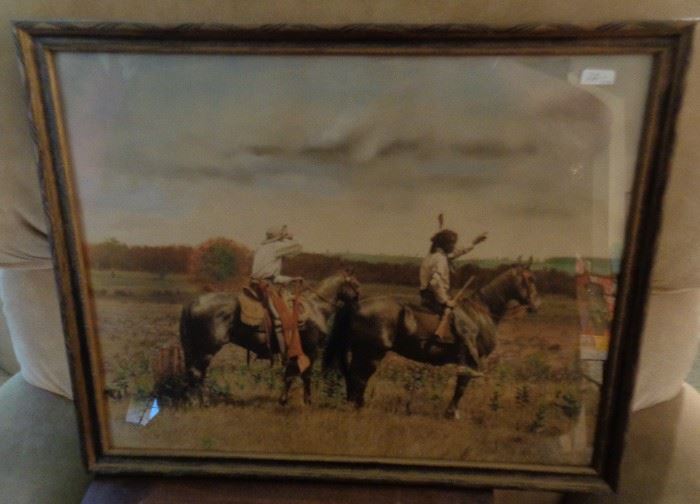 Hand tinted photo of a cowboy & Indian on horseback circa early 1900's.