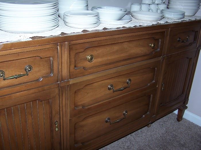 Buffet has top cabinet with glass doors
