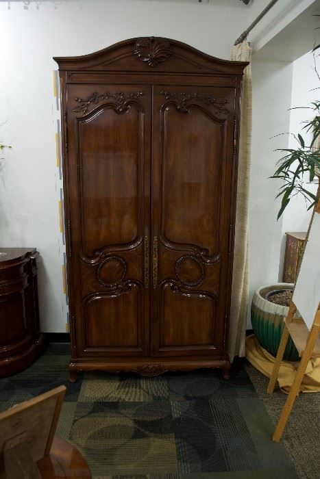 A country French armoire hand carved walnut solids, knotty white oak door and end panel veneers, carved crown and carved base.  By Karges Furniture Co.  (Appraised: $7,500).  For Sale: $1,900