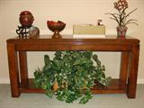 Wood buffet table with decorative items.