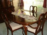 Q.C. Taiwanese dining table with 2 leaves and 8 chairs.