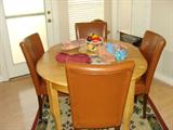 Breakfast table with leaf and 4 leather chairs.