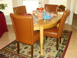 Breakfast table with leaf and 4 leather chairs.