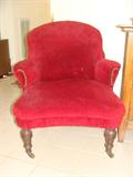 Antique red upholstered chair.
