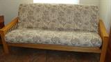 Light colored wood frame futon