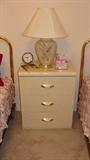 • White laminate dresser with round mirror
• While laminate night stand