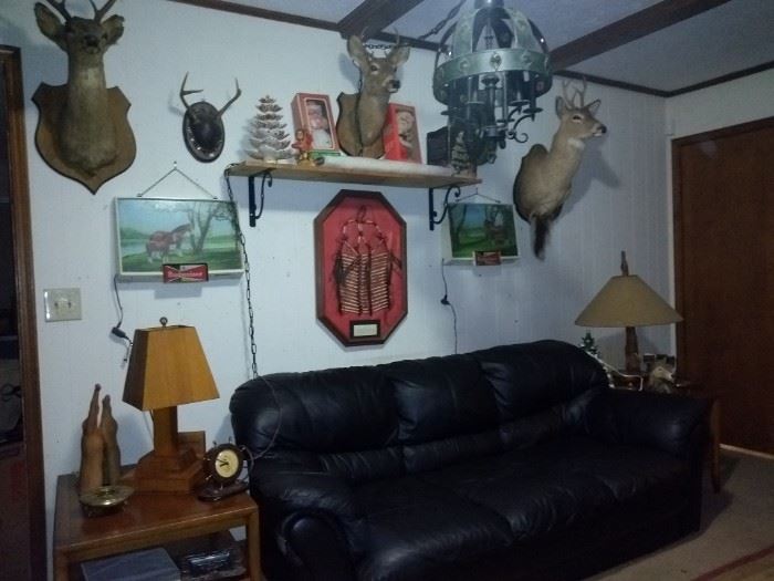 Living Room with Black Sofa and Deer Bust