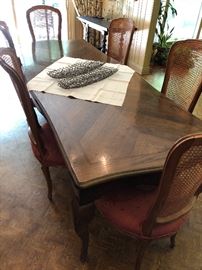 Dining table showing a different set of 6 cane back chairs
