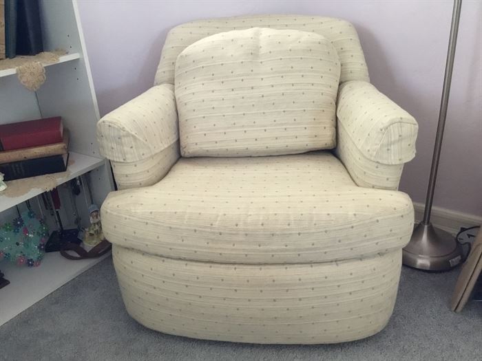 Small upholstered reading chair is covered with the same fabric.