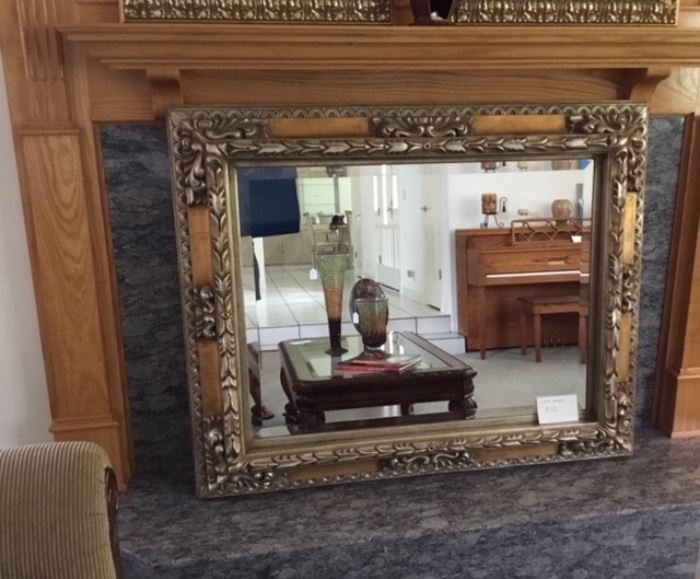 Large mirror with gold border.
