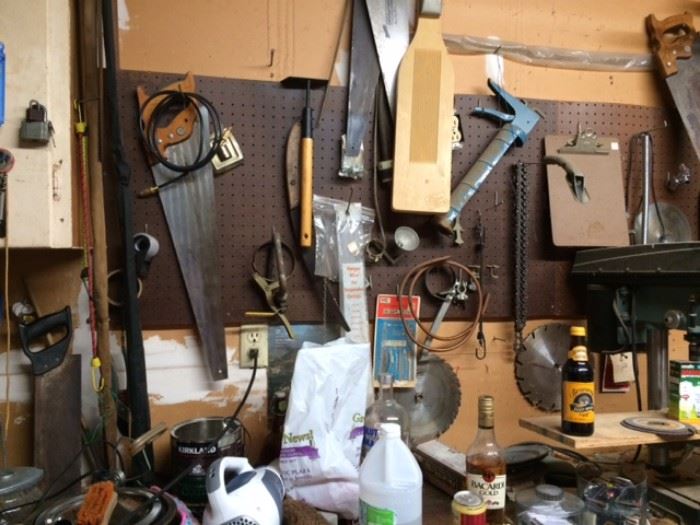 Single car garage full of tools. Saws, hammers, vices, caulking guns, screw drivers, mechanical saws with plates, cleaning supplies, peg board, clip board, sand paper, sanding tools, much more!