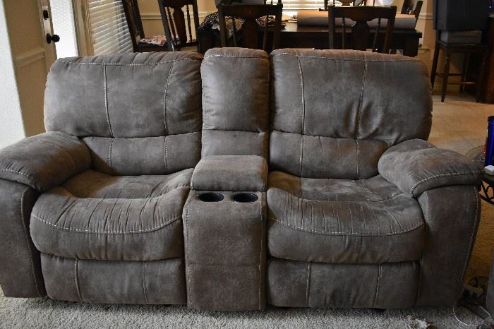 Microfiber electric recliners with drink holders and storage.