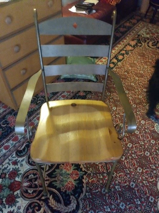 One of four metal and wood chairs